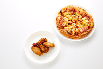 Pizza and fried chickens are white plate