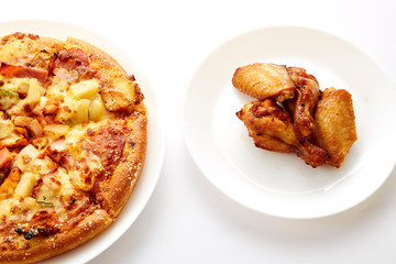 Pizza and fried chickens are white plate