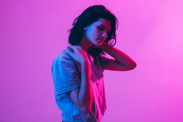 Portrait of beautiful woman. Pink, purple and blue light colors.