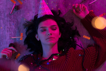 Young woman lying with glowing lights Celebration, Holiday, Birthday.