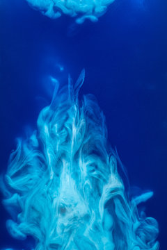 Abstract Pattern Falling Into The Water Drop Of Blue Ink - Cyan Ink Dissolved In Water On Blue