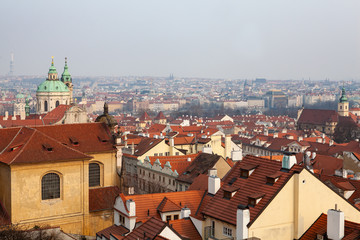 Naklejka na ściany i meble Peaceful view of Mala Strana in Prague with red tiled roofs and the baroque church of Saint Nicholas