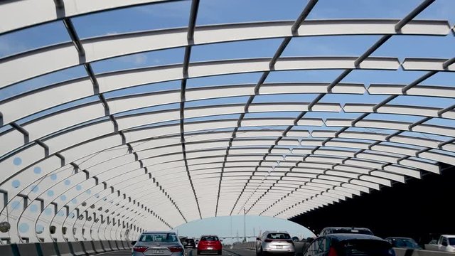 MELBOURNE - SEPTEMBER 6, 2018: Cars under metallic tunnel along the road from airport to city. The city attracts 15 million people annually