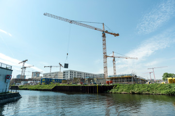 Operating crane at building site.