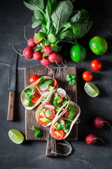 Vegetarian tacos as a small fresh appetizer on concrete table