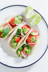 Top view of tasty tacos on white table