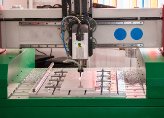 Automated CNC equipment for working with metal at factory. The programmed robot head.