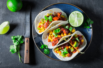 Mexican tacos with meat and lime on concrete table