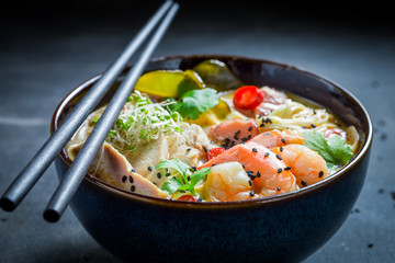 Closeup of delicious Malaysian Soup with chicken and shrimps
