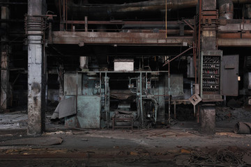 Destroyed equipment in an old abandoned car factory.