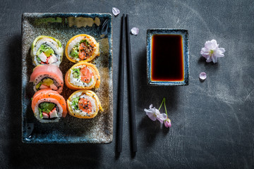 Sushi set with wasabi and soy sauce on concrete table