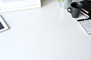 Workspace white top table with office gadget and copy space
