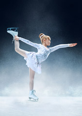 Little girl figure skating at the indoor ice arena. The dance, sport, winter, exercise, training, childhood, champion concept © master1305