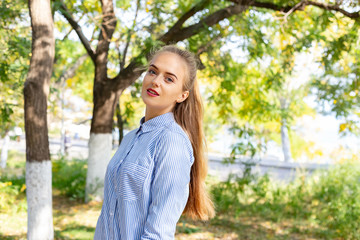 Naklejka premium Autumn woman portrait outdoors at the park