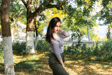 Autumn woman portrait outdoors at the park