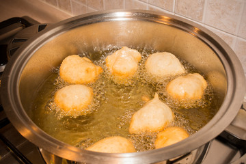 Dough Friying in a Pot during the Preparation of an Italian Christmas Traditional Dish called Pettole