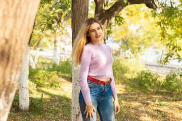 Autumn woman portrait outdoors at the park