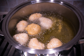 Dough Friying in a Pot during the Preparation of an Italian Christmas Traditional Dish called Pettole