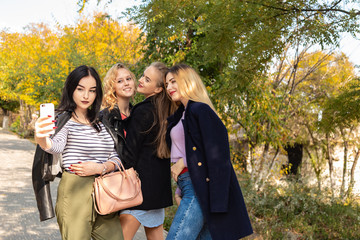 Summer autumn vacation, holidays, travel and people concept - group of young women in the park