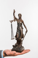 close-up partial view of businessman holding lady justice statue isolated on white
