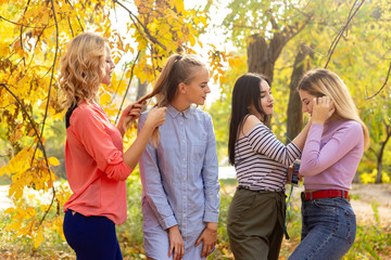 Summer autumn vacation, holidays, travel and people concept - group of young women in the park