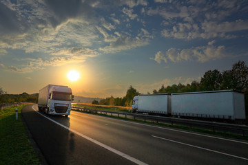 Truck transport on the road at sunset