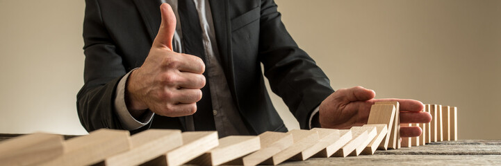 Wide view image of businessman showing thumbs up sign