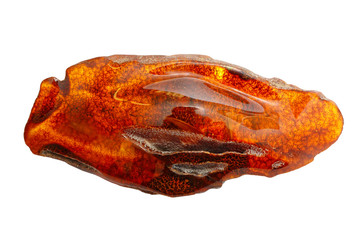 Beautiful polished piece of amber on a white background. Unusual forms of amber. Fossil ancient petrified resin. Amber piece of oblong shape. Products of nature. Sun Stone Amber Science