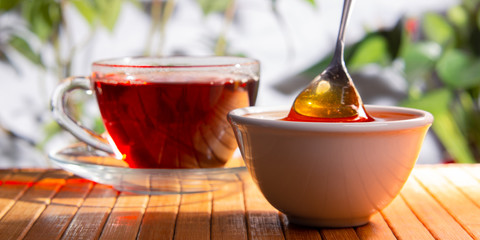 A cup of black tea and  honey