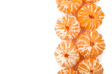 bunch of peeled tangerines or mandarins in a row