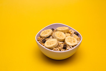 A bowl with banana, oats and cereal.