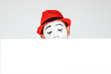 happy MIME artist holding a blank white Board, on a white background.