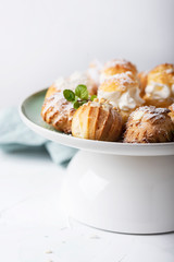 Delicious profiteroles with cream