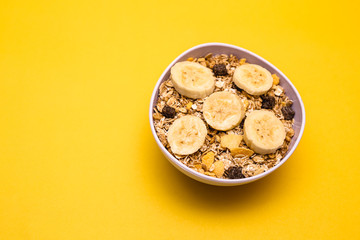 A bowl with banana, oats and cereal.