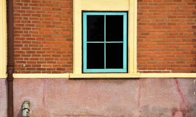antique blue wood window at red brick building