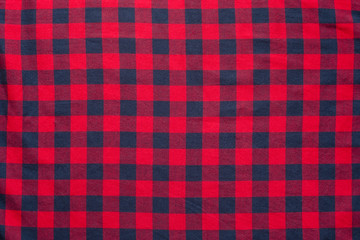 Obraz premium Checkered plaid material. Red dark blue cage clothes background