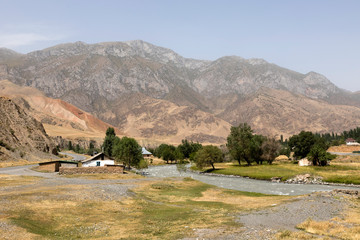 Village with landscape and river around the famous Pamir Highway M41 in Kyrgyzstan in Central Asia