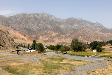 Fototapeta premium Village with landscape and river around the famous Pamir Highway M41 in Kyrgyzstan in Central Asia