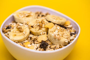 A bowl with banana, oats and cereal.