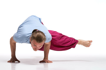 Bearded longhair man practicing yoga. Model doing exercises isolated on white background. Eka Pada Kaundiniasana pose. Full length