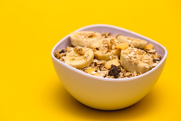 A bowl with banana, oats and cereal.