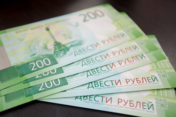 Russian money in the hand on a gray background.