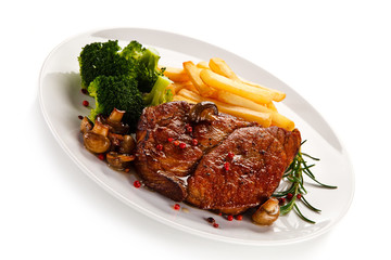 Grilled beefsteak with french fries and broccoli on white background
