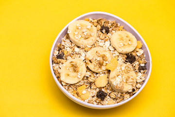 A bowl with banana, oats and cereal.