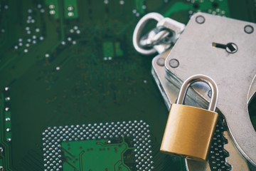 Digital security concept: Closed lock with handcuffs on the background of a computer chip with copy space