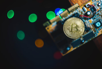  Bitcoin on the electronic board, video card for blockchain mining. Background for text, christmas lights.