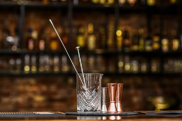 A glass and measuring cup for making drinks and cocktails in a pub, bar.