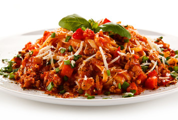 Pasta with bolognese sauce on white background