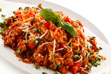 Pasta with bolognese sauce on white background