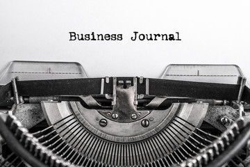 Business journal, text is typed on an old vintage typewriter with white paper. Business idea